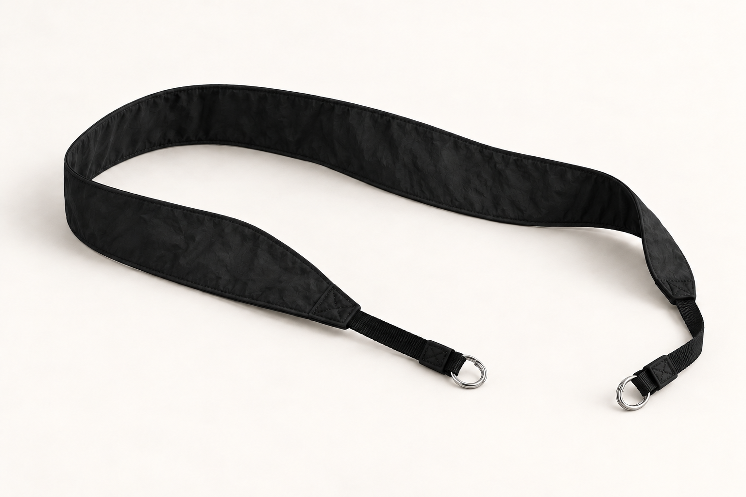 Monofloat camera strap concept in black, with split-ring ends for camera lugs.