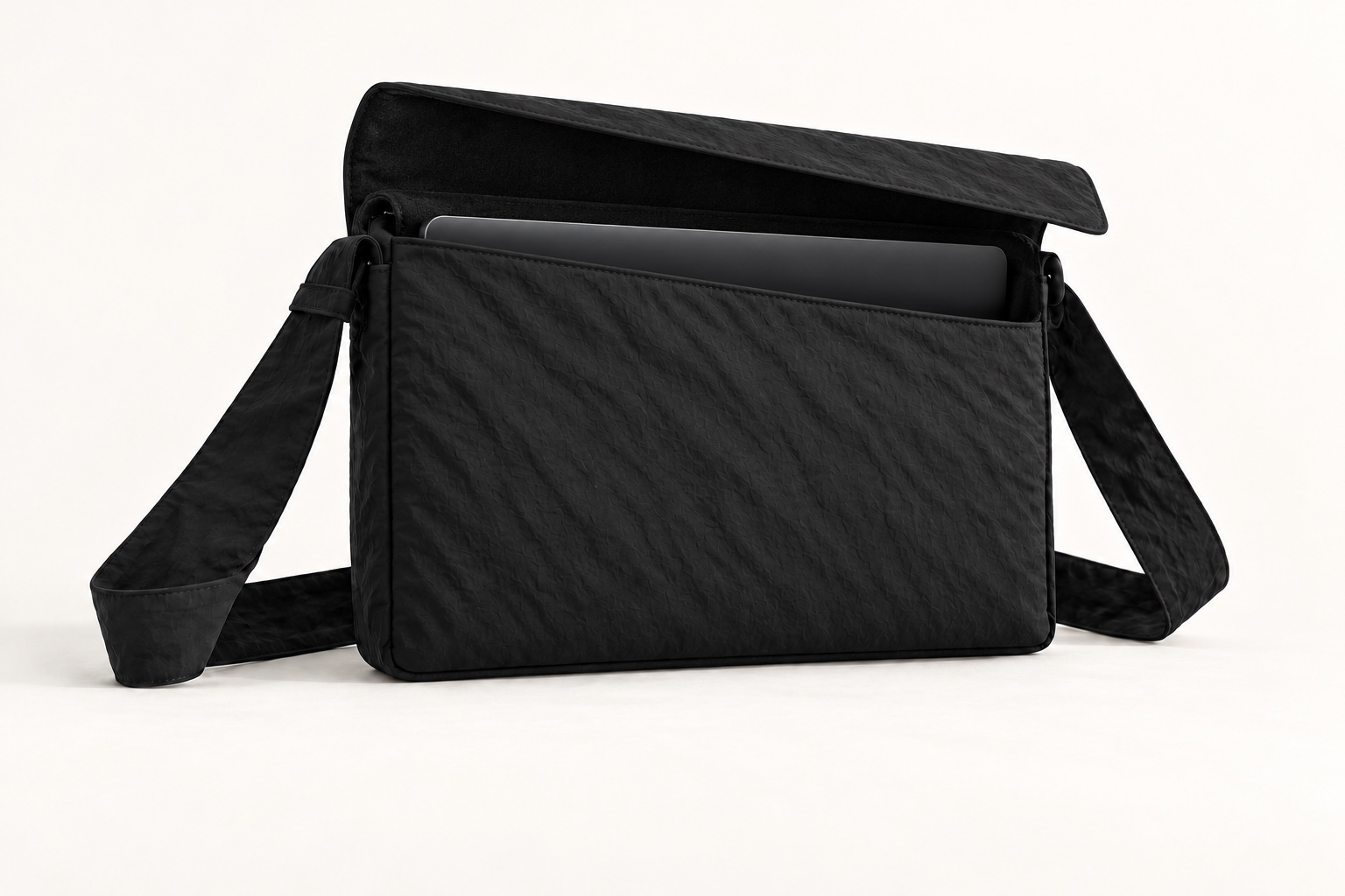 Open laptop carry concept showing a laptop edge in its softly lined main compartment.